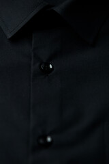 Close up of dark Men's shirt. Soft focus. Copy space.	