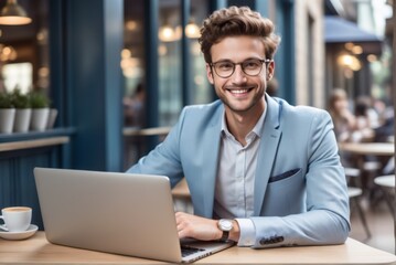 Fototapeta premium Young young smiling young man sitting wooden table laptop front