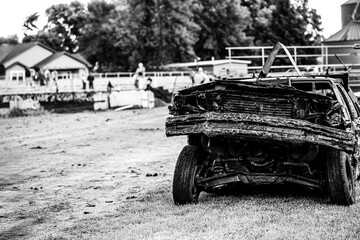 Selective focus on the front end of a wrecked car after impact in a demolition derby.