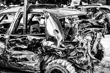 Dented and damaged rear end of a modified car used for a demolition derby.