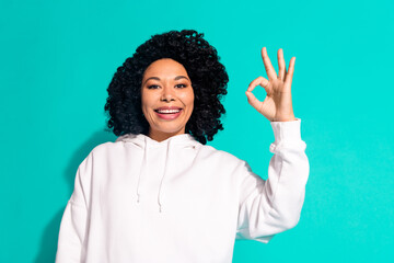 Photo portrait of young funny chevelure hairstyle lady wearing white hoodie good job symbol okey isolated on aquamarine color background