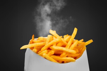 Tasty fast food french fries with smoke