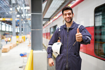 Technician or worker smiling and thumbs up pose at construction train station
