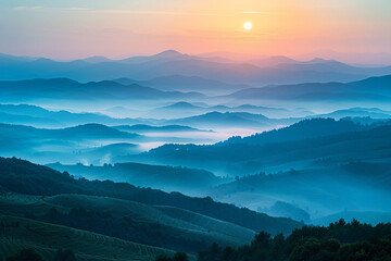 Fototapeta premium Misty morning mountains with fog enveloping the landscape under a soft sunrise