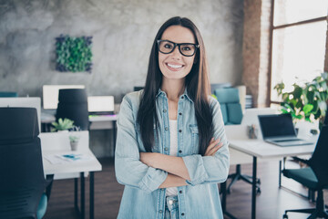Photo of happy charming lady secretary wear denim jacket smiling arms folded indoors workshop...