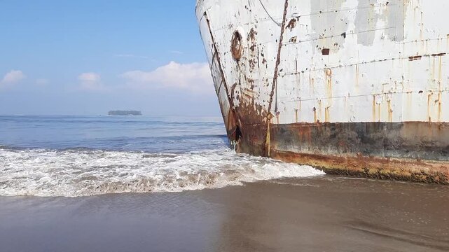 An old big ship that was damaged and had a leak in the front hull