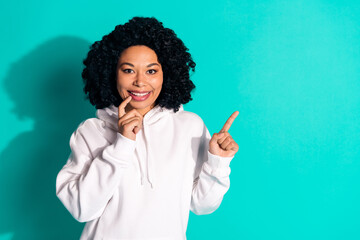 Photo of young funny chevelure hairstyle lady wearing white hoodie admiring point finger copyspace gifts store isolated on cyan color background