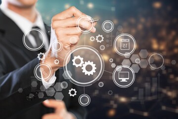 Businessman pointing on a virtual screen with usiness icons