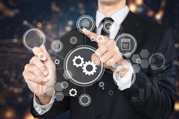 Businessman pointing on a virtual screen with usiness icons