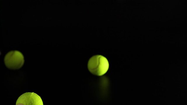 Tennis Balls Bouncing in Darkness
