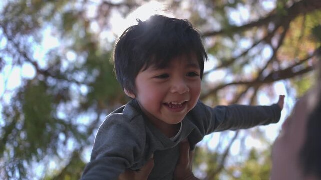 Mexican little boy playing with his father outside, international children day rights