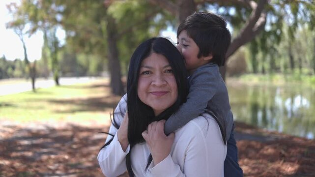 Mexican mother having fun with her son outdoors 4K video