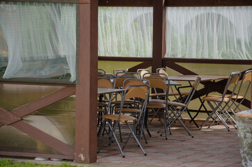 Summer tent with chairs stacked outside for celebration