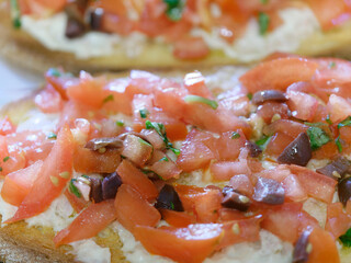 delicious bruschetta with tomatoes, olives, basil and mayonnaise