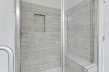 Modern Bathroom With Large Glass Shower And Textured Tile Walls