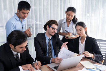 Diverse of business people from various ethnic group working in modern office environment. Productive and multi ethnic office workers engage in discussion for strategic business marketing. Meticulous