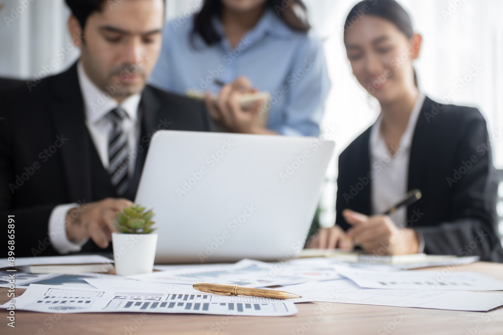 Aufkleber piles of analyzed financial data dashboard on meeting table with background of business people analy