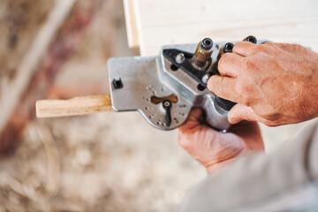Carpenter using professional equipment assembling furniture
