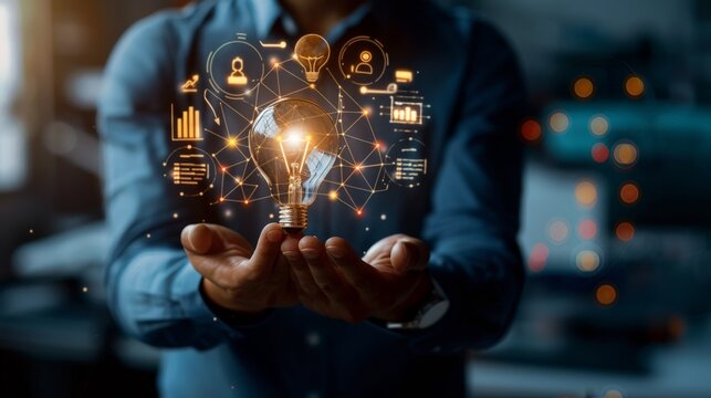 Businessman holding creative light bulb with growth graph and knowledge management system icons. Utilizing innovation technology to develop new strategies and solutions that enhance successful