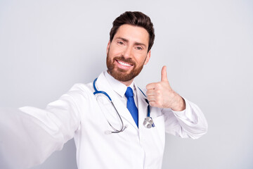 Photo of professional qualified doctor make selfie thumb up wear white coat isolated on grey color background