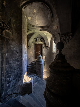 Old dark enlighted decaying Stairwell in Italy
