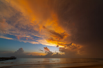 .aerial view amazing cloud in colorful sky at sunset above the ocean..The bridge plunges into the sea water reflected from the sky..Majestic sunset landscape Amazing light of nature cloudscape sky..