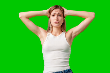 Young Woman Holding Her Head in Frustration Against Green Screen