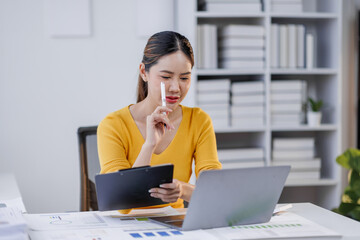 Business and Financial concept. asian Business woman discussing assessment and evaluation of corporate showing clipboard report results of their successful teamwork.