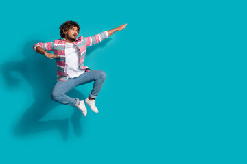 Photo of funny sportsman young man wear stylish striped clothes fight look empty space isolated on cyan color background