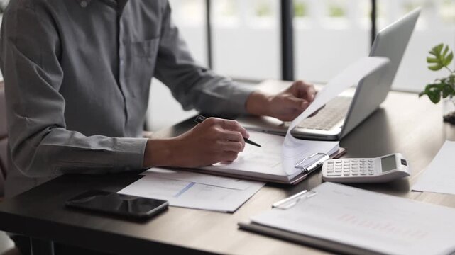 Auditor reading a report documents in office