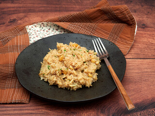 A serving of Iç Pilav, a traditional Turkish rice dish with currants and pine nuts, presented on a dark plate