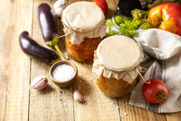 Healthy homemade fermented food. Salad eggplant with vegetables a rustic table. Home economics, autumn harvest preservation.