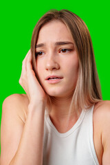 Young Woman With Blonde Hair Looking Worried In Front Of Green Screen