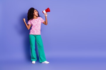 Full body photo of attractive young woman megaphone scream announce empty space dressed stylish clothes isolated on violet color background