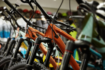 Closeup view on row of new modern mountain bicycle at sports showroom