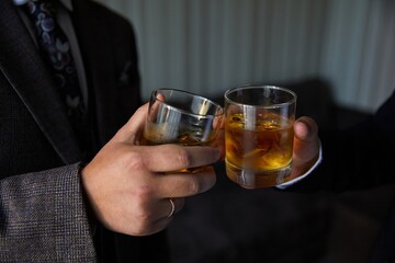 two glasses of whiskey are being checked