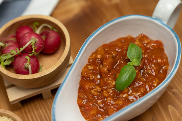 Health food's recipe ingredients of special menu homemade cooking sauce with tomato and basil of macro photo shooting placing elements on preparing wooden table surround blurred background. Postulate.