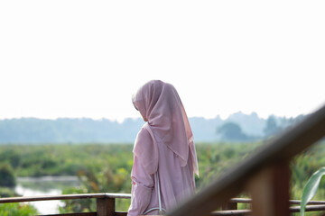 A woman enjoying the view of a large wetland or swamp in the morning