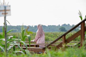 A woman enjoying the view of a large wetland or swamp in the morning