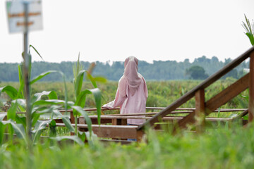 A woman enjoying the view of a large wetland or swamp in the morning