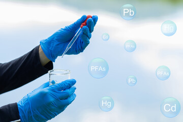 Hands are examining the quality of wastewater treatment systems to control chemicals before...