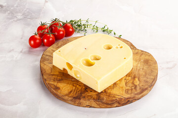 Maasdam cheese brick over board