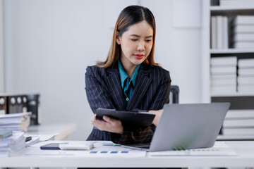 Business asian woman in the workplace analyse investment marketing analytical charts and graphs data business people business financing accounting banking concept.