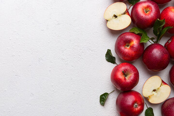 Fresh red apples with green leaves on wooden table. On wooden background. Top view free space for text