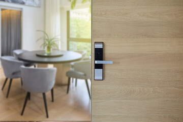 Digital Door handle or Electronics knob  for access to room security, Door wooden half opening through interior living room background, selective focus