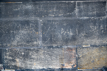 Old stone wall texture with dirt and scratches. Old medieval european city.
