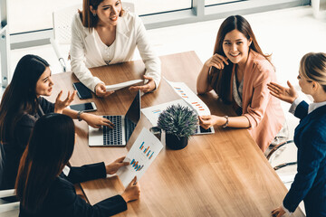 Businesswoman in group meeting discussion with other businesswomen colleagues in modern workplace...