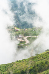 Morning mist with the greenery hill peak in rainy season. Beautiful nature scenic view photo.
