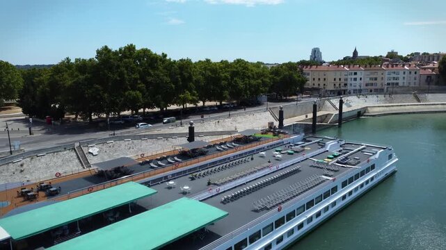 Rhone river passing through the city of Arles in Provence. Ferries and boats in the important river in Europe that flows into the Mediterranean. Towns along the river that attract tourists traveling.