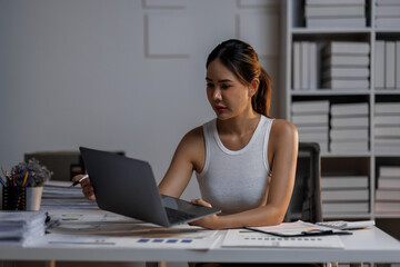 Modern young asian woman working remotely from home at night. night worker